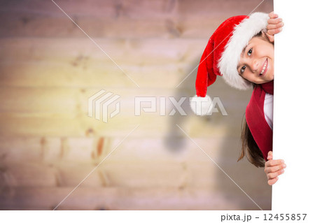 Composite image of festive little girl showing card Composite image of festive little girl showing card 12455857