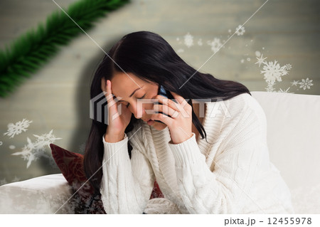 Composite image of woman suffering from a migrane 12455978