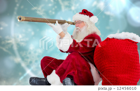 Composite image of santa claus looking through telescope Composite image of santa claus looking through telescope 12456010