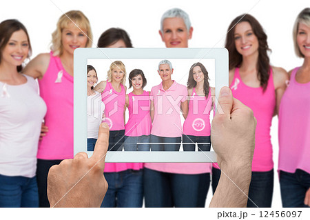 Composite image of hand holding tablet pc Composite image of hand holding tablet pc 12456097