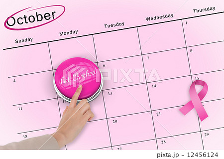 Hand pushing pink button for breast cancer awareness Hand pushing pink button for breast cancer awareness 12456124