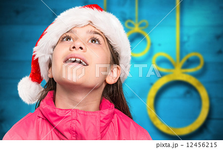 Composite image of festive little girl looking surprised 12456215