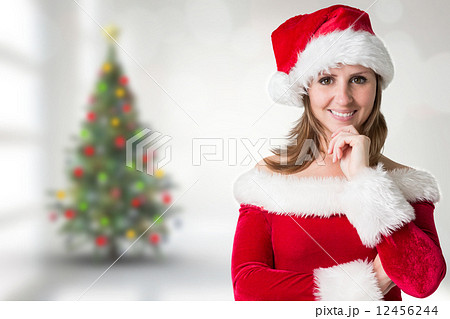 Composite image of pretty girl in santa outfit 12456244