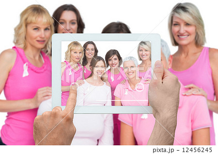 Composite image of hand holding tablet pc Composite image of hand holding tablet pc 12456245