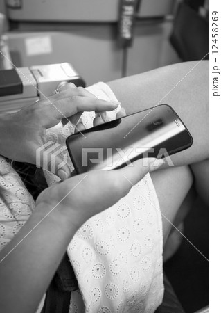 Monochrome shot of woman sitting in airplane and typing text on Monochrome shot of woman sitting in airplane and typing text on 12458269
