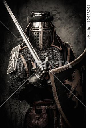 Medieval knight with a sword against stone wall Medieval knight with a sword against stone wall 12468291