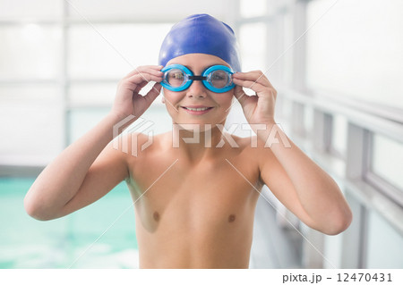 Cute little boy standing poolside 12470431