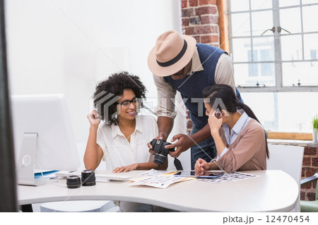 Concentrated casual photo editors at work 12470454