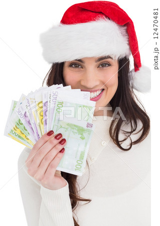 Festive brunette holding her cash 12470481