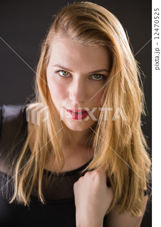 Cheerful attractive blonde with black dress posing Cheerful attractive blonde with black dress posing 12470525
