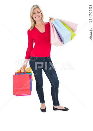 Happy blonde holding shopping bags 12470533