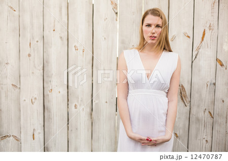 Elegant blonde woman standing while looking at camera Elegant blonde woman standing while looking at camera 12470787