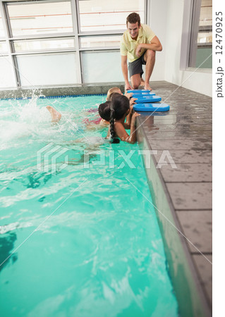 Cute swimming class listening to coach 12470925