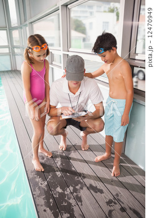 Swimming coach with his students 12470949