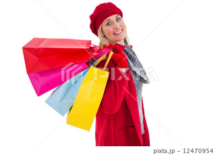 Blonde in winter clothes holding shopping bags Blonde in winter clothes holding shopping bags 12470954