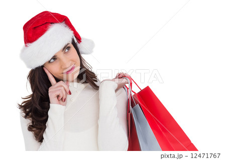 Festive brunette holding shopping bags and thinking Festive brunette holding shopping bags and thinking 12471767