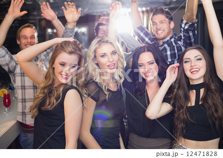 Stylish friends dancing and smiling Stylish friends dancing and smiling 12471828