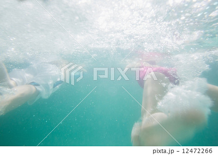 Cute kids swimming underwater in pool Cute kids swimming underwater in pool 12472266