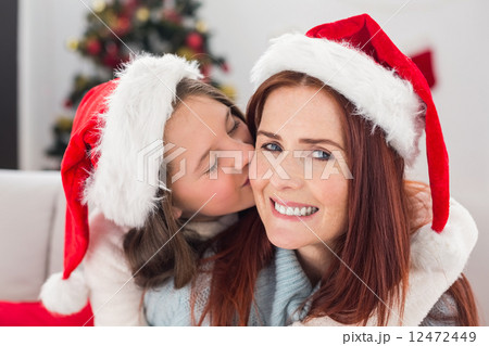 Festive mother and daughter on the couch Festive mother and daughter on the couch 12472449