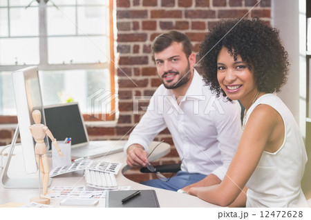 Smiling photo editors in office Smiling photo editors in office 12472628