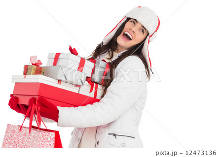 Brunette in winter clothes holding many gifts and shopping bags Brunette in winter clothes holding many gifts and shopping bags 12473136