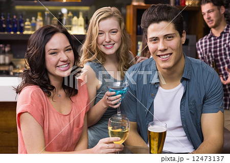 Young friends having a drink together 12473137