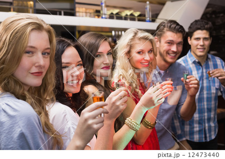 Happy friends having a drink together 12473440