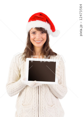 Festive brunette holding a tablet pc 12473564