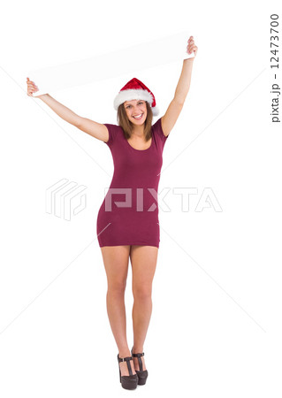 Girl standing upright while holding a poster above her head 12473700