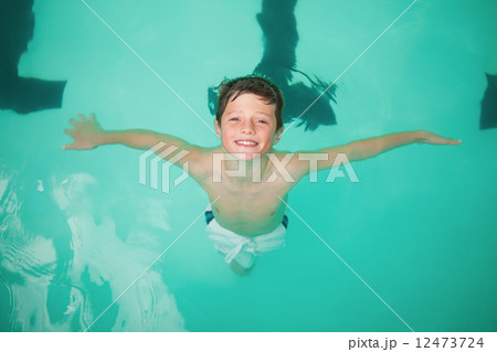 Cute little boy smiling in the pool 12473724