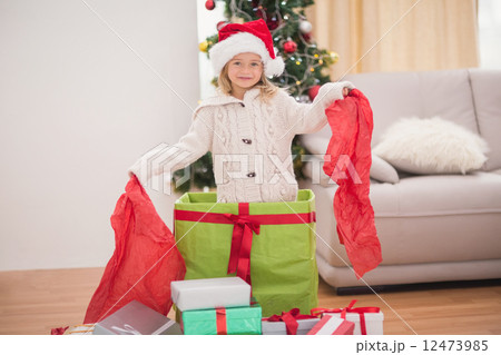 Cute little girl sitting in giant christmas gift Cute little girl sitting in giant christmas gift 12473985