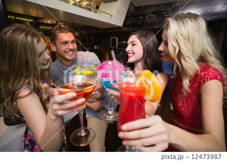 Happy friends having a drink together Happy friends having a drink together 12473987