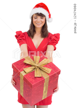 Festive brunette giving a gift Festive brunette giving a gift 12474060