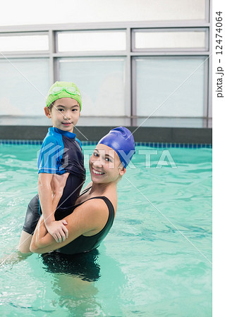 Cute little boy learning to swim with coach Cute little boy learning to swim with coach 12474064