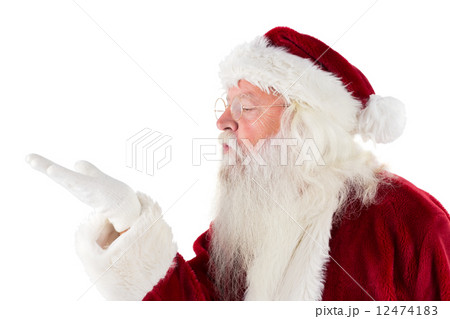 Santa Claus blows something away 12474183