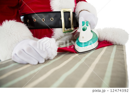 Father christmas ironing his hat 12474392
