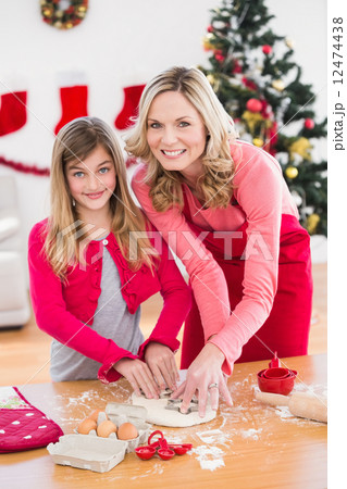 Festive mother and daughter making christmas cookies Festive mother and daughter making christmas cookies 12474438