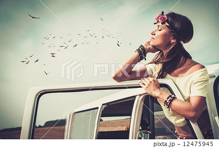 Hippie girl in a minivan on a road trip 12475945