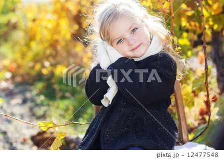 Adorable little girl in warm clothes, autumn time Adorable little girl in warm clothes, autumn time 12477548
