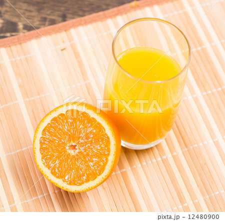 orange and a glass of orange juice 12480900