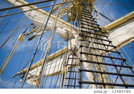 Sails and tackles of a sailing vessel on a background of the sky Sails and tackles of a sailing vessel on a background of the sky 12484789
