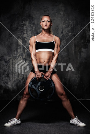 Beautiful muscular bodybuilder woman with weights Beautiful muscular bodybuilder woman with weights 12485810