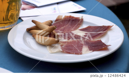 Jamon iberico (prosciutto) ham with extra virgin oil baked picos Jamon iberico (prosciutto) ham with extra virgin oil baked picos 12486424