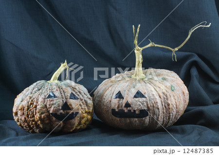 Human skulls and pumpkin on black background, Halloween day background. 12487385