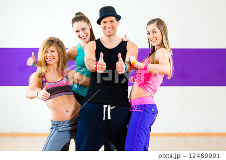 Man posing with woman in zumba dance school 12489991