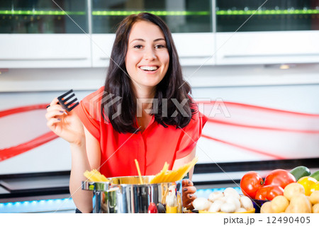 Woman cooking pasta in domestic kitchen Woman cooking pasta in domestic kitchen 12490405