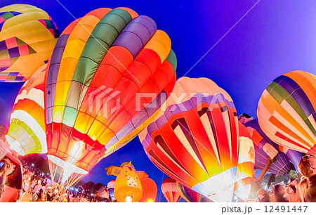 Bright Hot Air Balloons Glowing at Night Bright Hot Air Balloons Glowing at Night 12491447