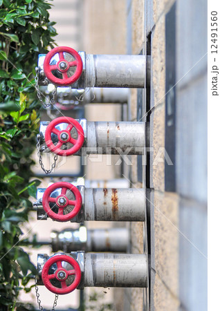 multiple fire department connections on a building wall multiple fire department connections on a building wall 12491560
