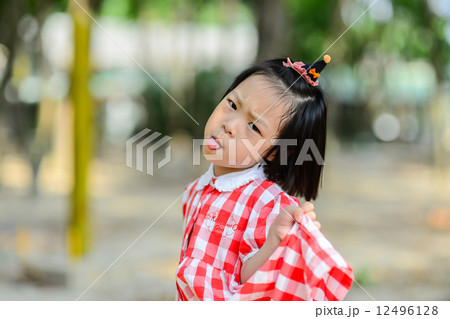 Cute Asian girl show her tongue and funny face. Cute Asian girl show her tongue and funny face. 12496128