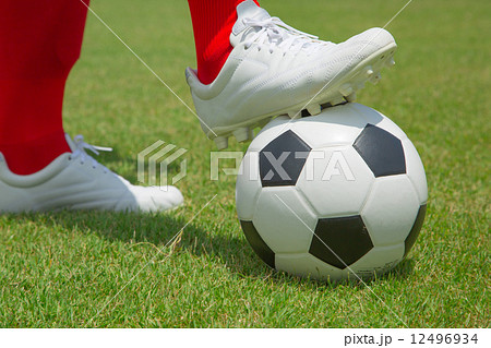 Soccesr player and ball isolated Soccesr player and ball isolated 12496934